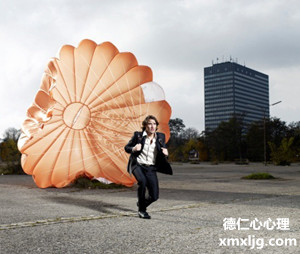 Man with parachute landing